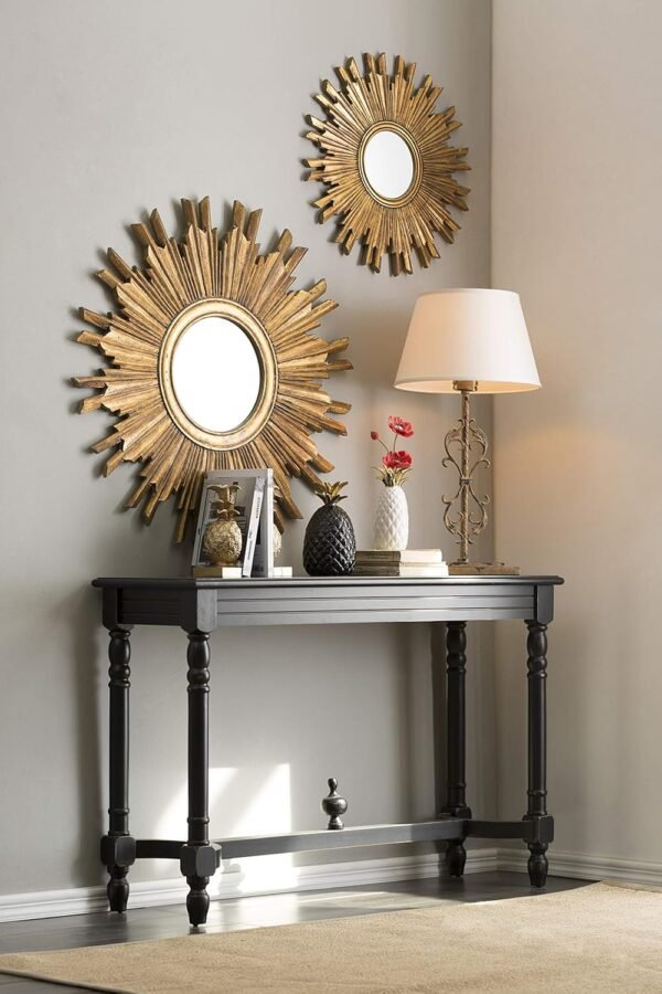 Gold sunburst wall mirror with intricate gilded wood frame, circular design radiating elegant rays, 35.5 inches in diameter.