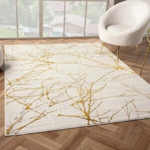 Modern Gold abstract area rug Gold Accented Area Rug with a cream base and metallic gold accents, featuring a tree branch-like design, placed in a stylish living room with wooden floors."