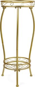 Elegant gold metal plant stand with a decorative scroll design, featuring a sturdy three-legged structure and two-tier storage for potted plants.