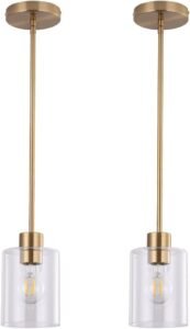 Set of two gold pendant light fixtures with brass finish and clear glass shades, featuring adjustable rods for modern kitchen or bar lighting.