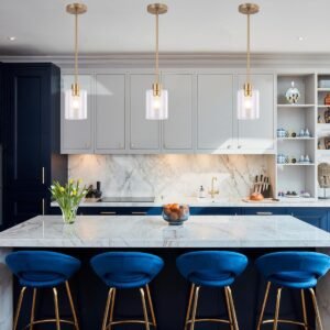 Set of two gold pendant light fixtures with brass finish and clear glass shades, featuring adjustable rods for modern kitchen or bar lighting. The Perfect accent for any room!